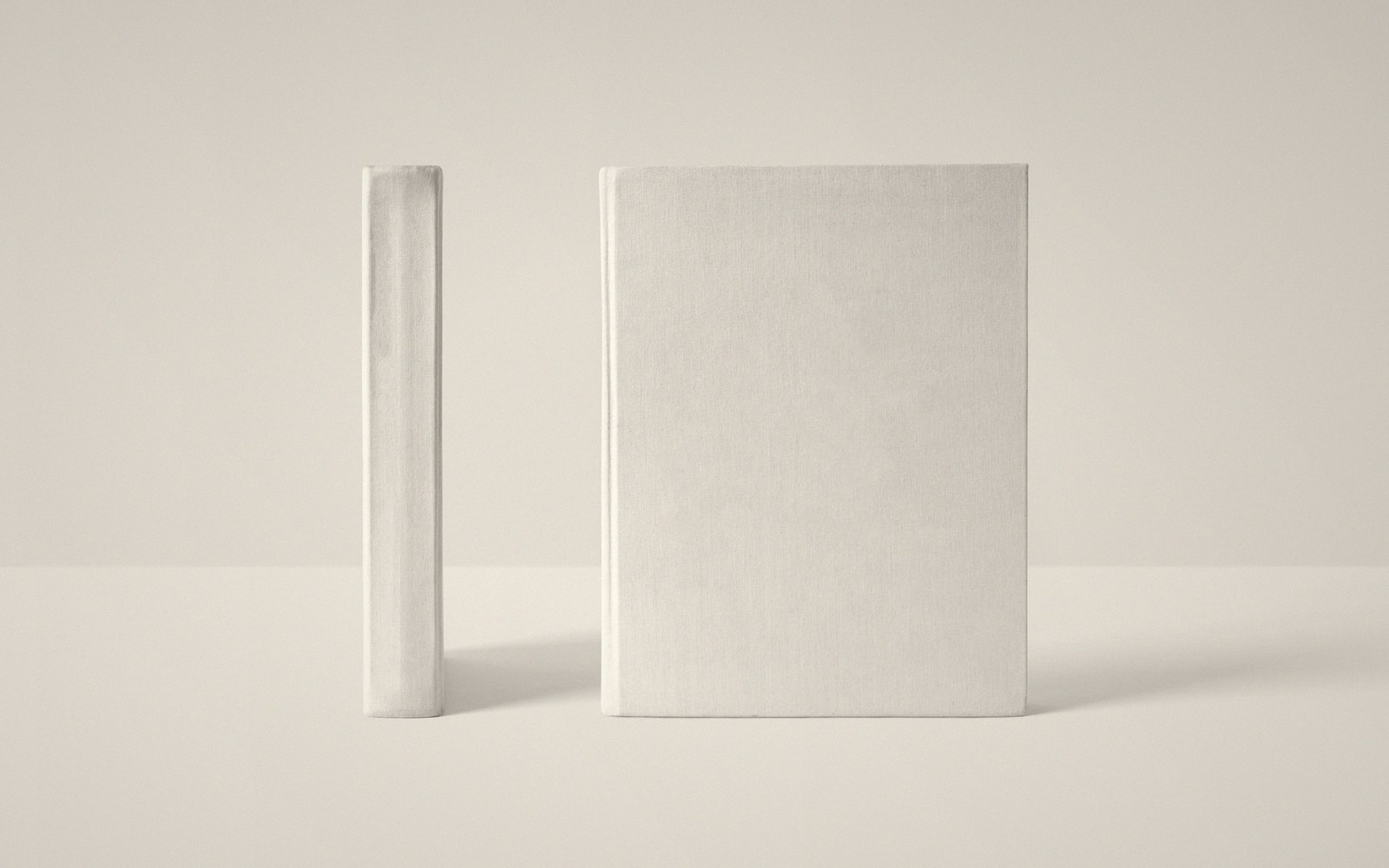 A book dummy open flat with a pencil beside it