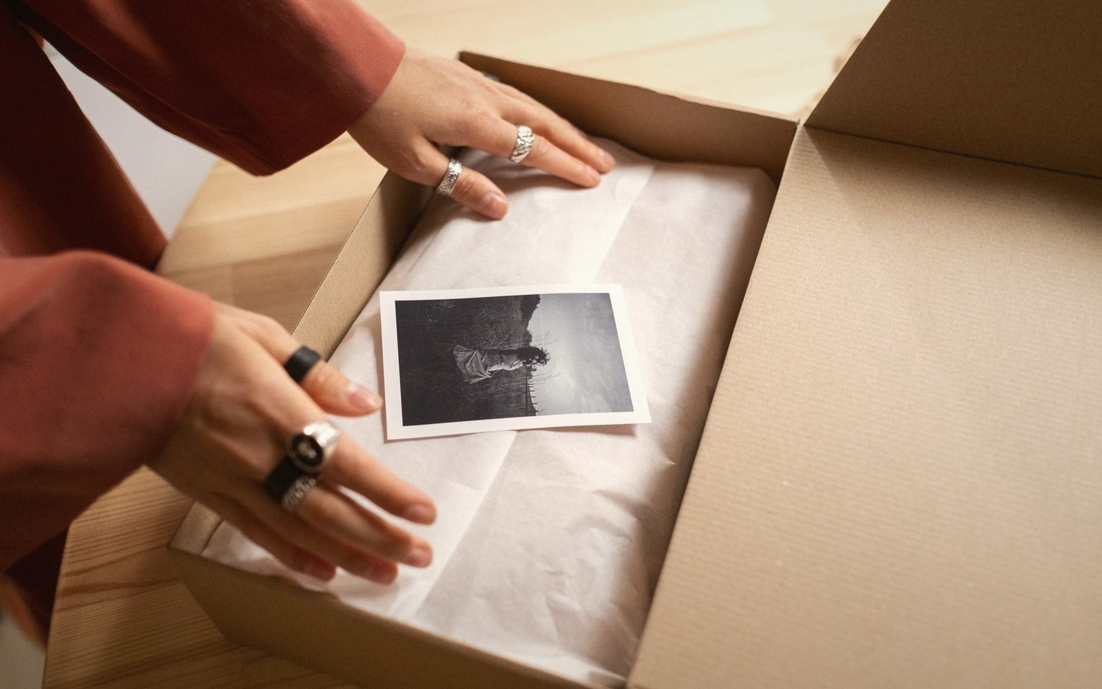 An open box of photographic paper with sheets fanned